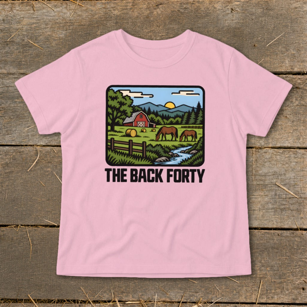 A pink children's t-shirt displays a farm graphic with horses, a red barn, and the text "The Back Forty".