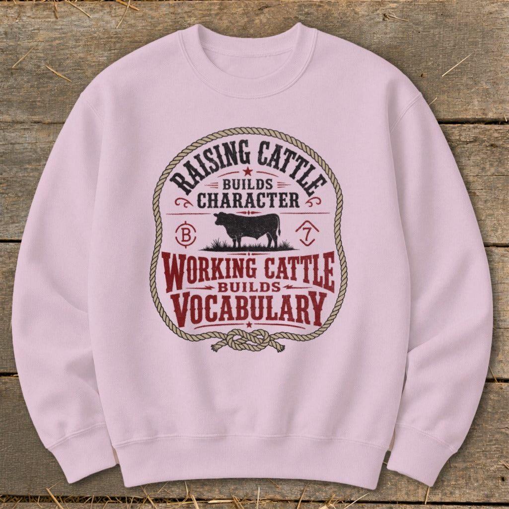 Light pink sweatshirt with a circular graphic about raising and working cattle.