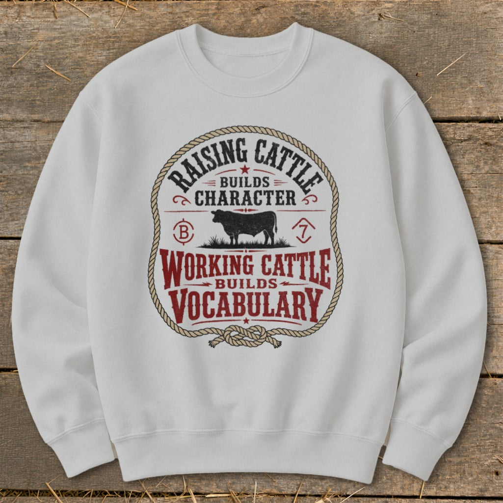White sweatshirt with "Raising Cattle Builds Character Working Cattle Builds Vocabulary" graphic.