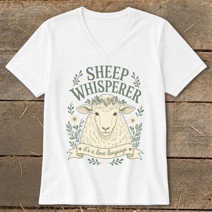 White t-shirt with "Sheep Whisperer" text and a sheep illustration with a floral wreath.