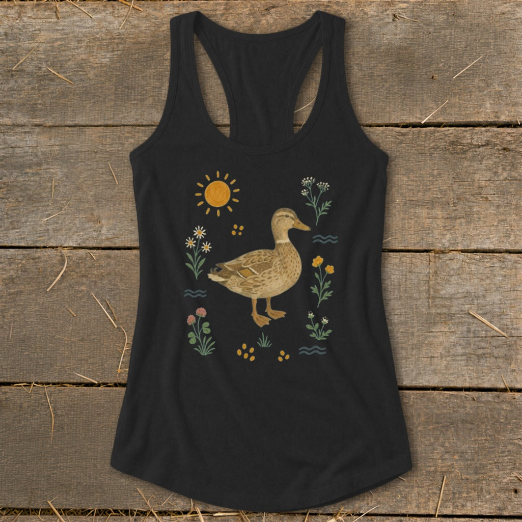 Black tank top with a duck surrounded by flowers, sun, and water illustration.