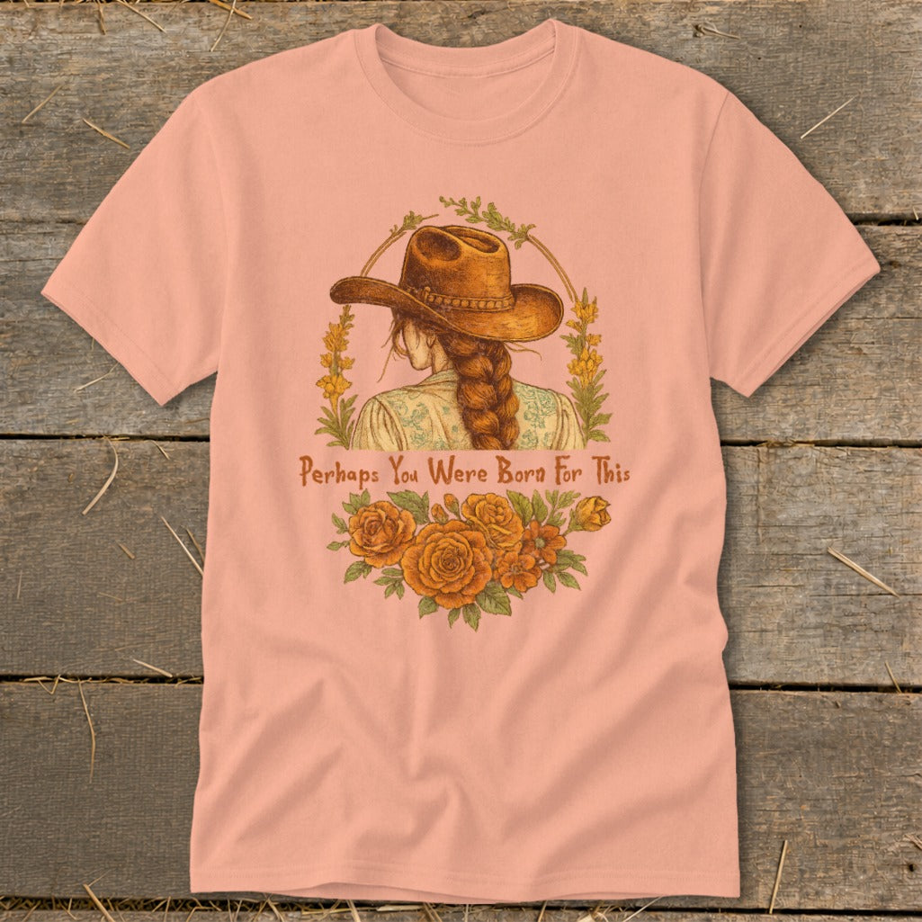 Peach t-shirt with illustration of a woman wearing a cowboy hat and the text "Perhaps You Were Born For This."