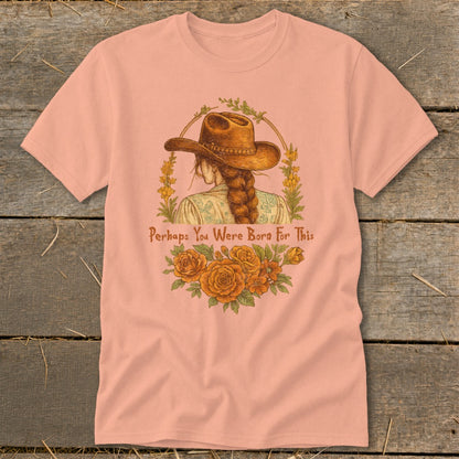 Peach t-shirt with illustration of a woman wearing a cowboy hat and the text "Perhaps You Were Born For This."