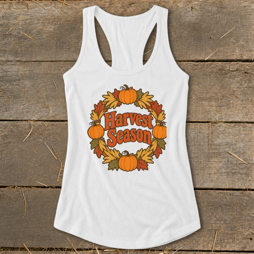 White tank top with "Harvest Season" in a circular wreath of pumpkins and leaves.