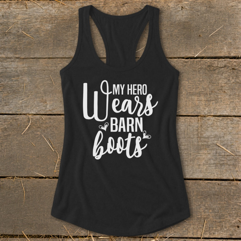 Black racerback tank top with white text reading "My Hero Wears Barn Boots".