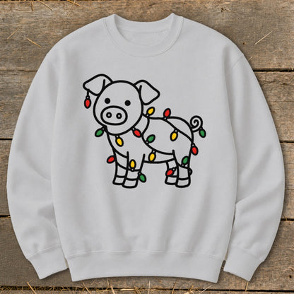 A light gray crewneck sweatshirt featuring a line drawing of a pig wrapped in Christmas lights.
