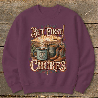 Crewneck sweatshirt with "But First, Chores" text, coffee mug, feed bucket, and cowboy boots graphic.