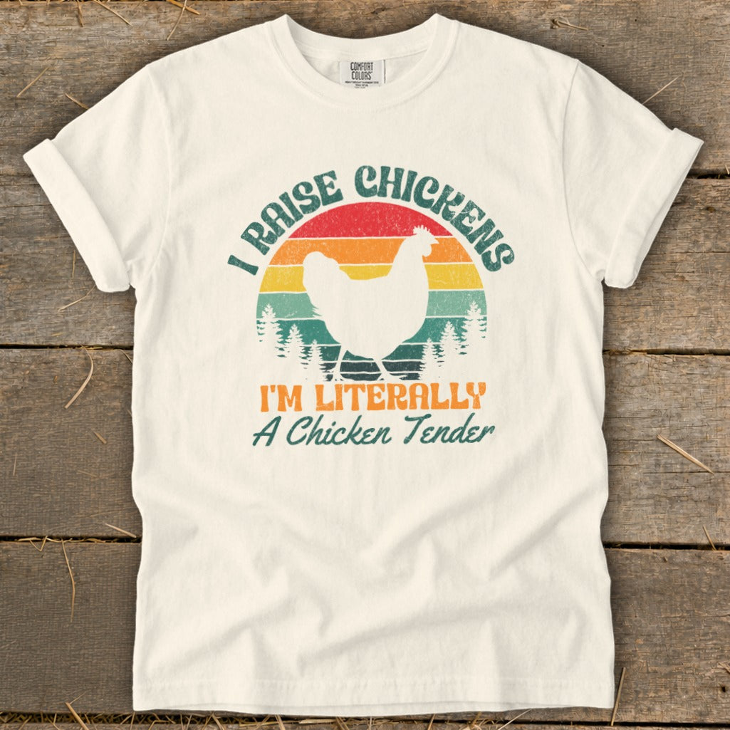 Cream t-shirt with "I Raise Chickens I'm Literally A Chicken Tender" text and chicken graphic.