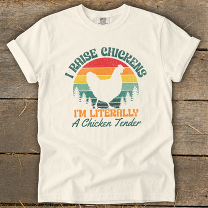 Cream t-shirt with "I Raise Chickens I'm Literally A Chicken Tender" text and chicken graphic.