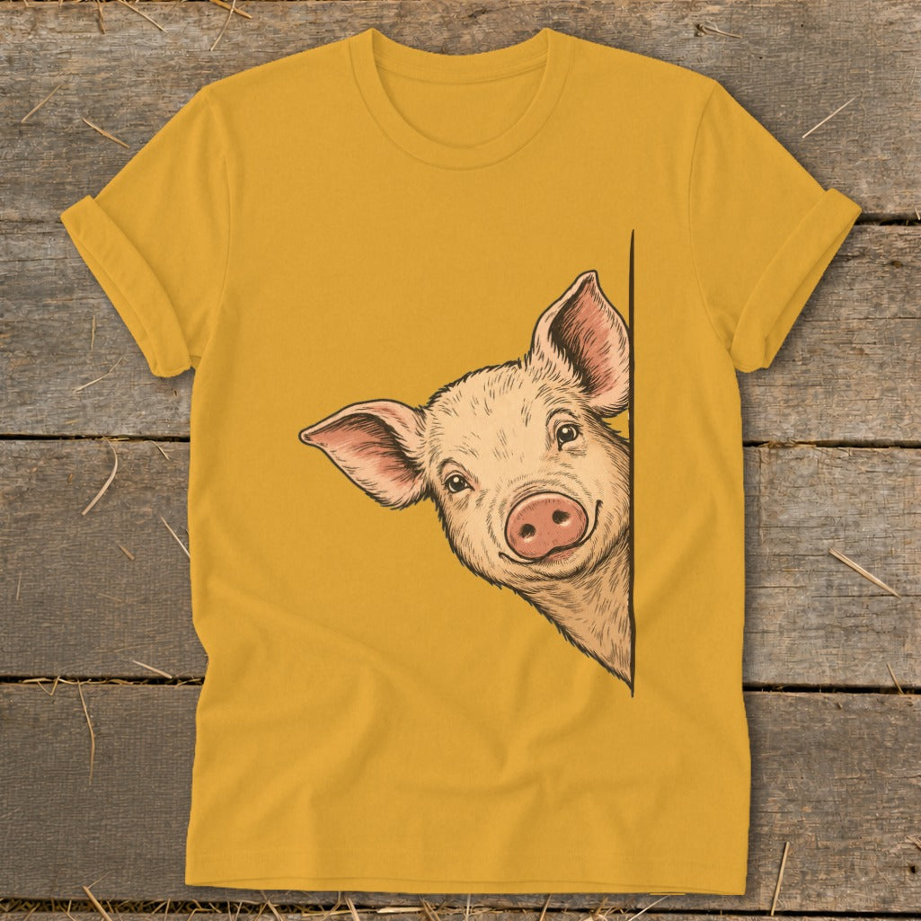 Illustration of a smiling pig peeking from behind a corner on a mustard yellow t-shirt.