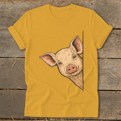 Illustration of a smiling pig peeking from behind a corner on a mustard yellow t-shirt.