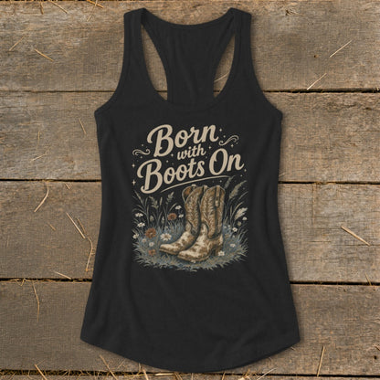 Black tank top with "Born with Boots On" text and cowboy boots in grass.