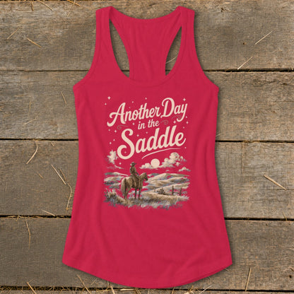 Pink tank top with "Another Day in the Saddle" graphic and cowboy on horseback.