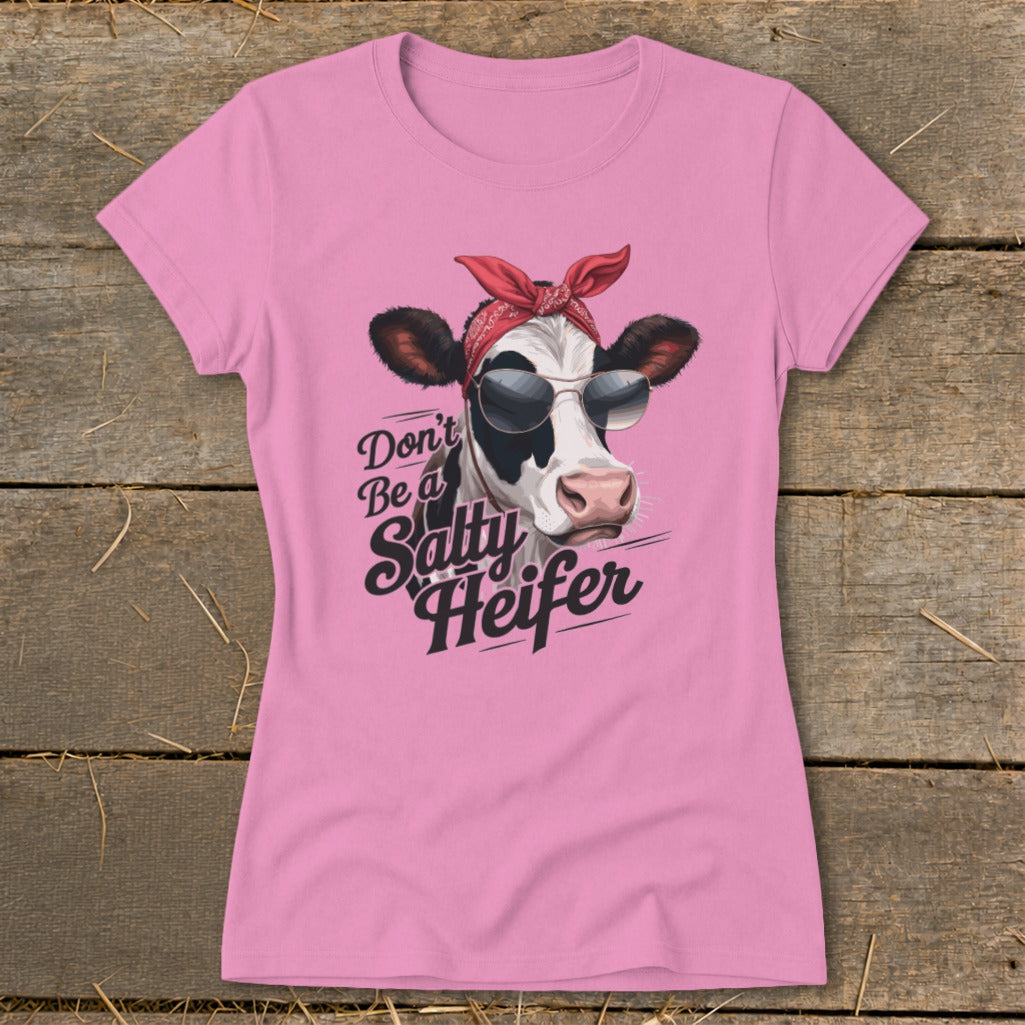Pink t-shirt with a cow wearing sunglasses and bandana, text reads "Don't Be a Salty Heifer."