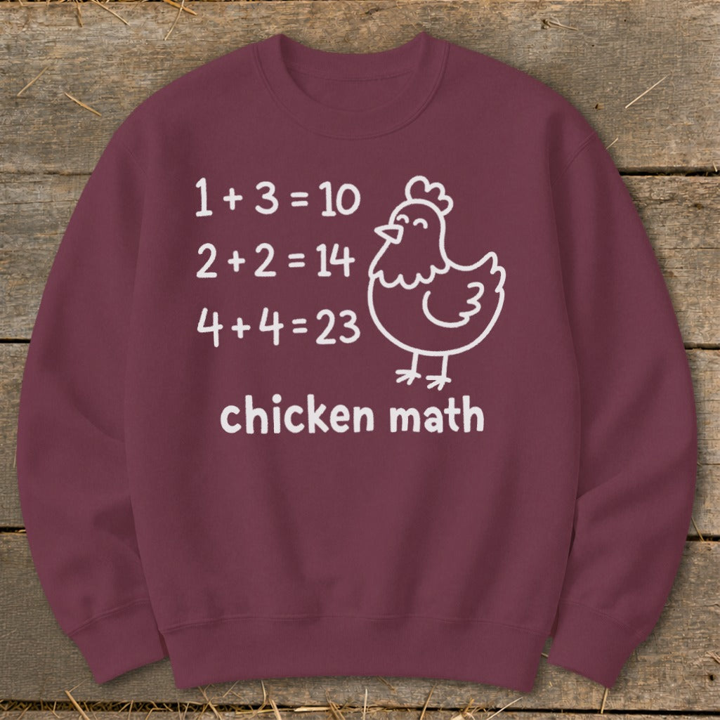Maroon sweatshirt with white text "1+3=10, 2+2=14, 4+4=23, chicken math" and chicken illustration.