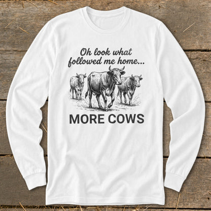 White long-sleeve shirt with cows and text "Oh look what followed me home... MORE COWS".