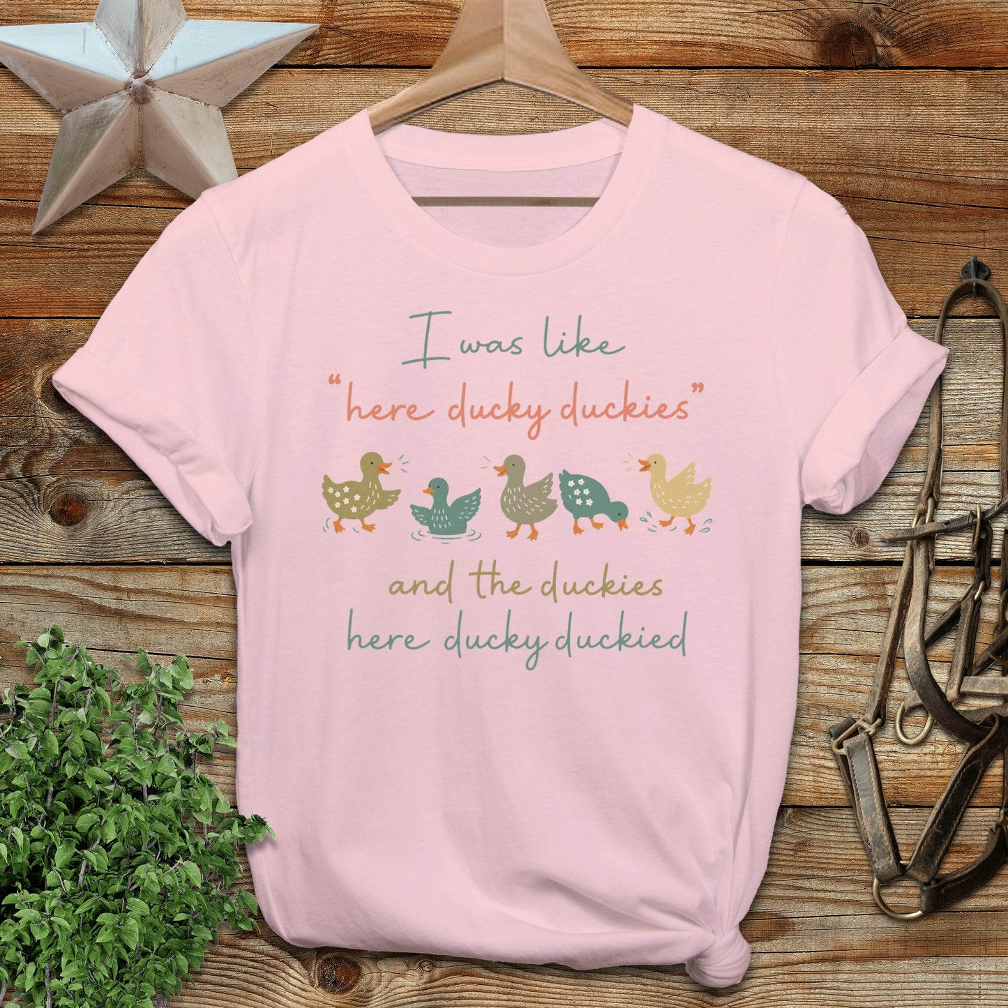 Light pink t-shirt with colorful ducks and text: "I was like 'here ducky duckies' and the duckies here ducky duckied."