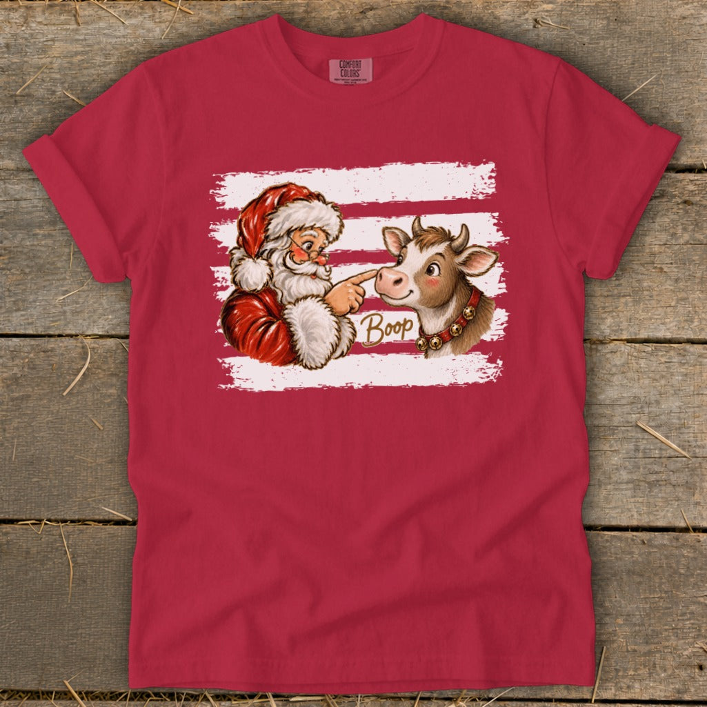 Santa boops a cow on the nose, with the word "Boop" on a red shirt.