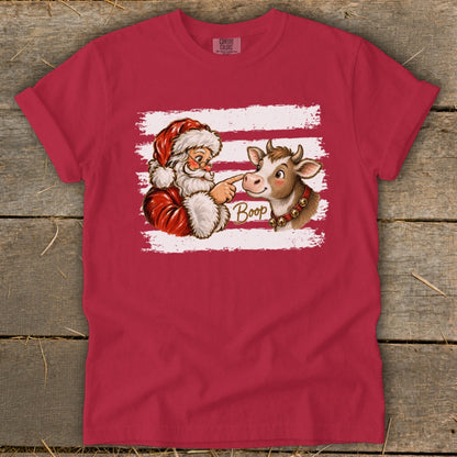 Santa boops a cow on the nose, with the word "Boop" on a red shirt.