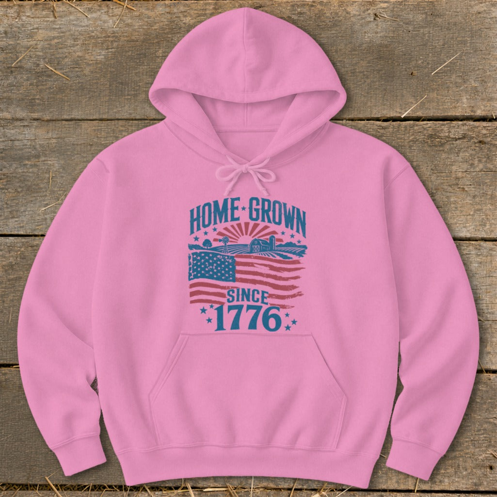 Pink hoodie with "HOME GROWN SINCE 1776" graphic featuring American flag and farm scene.