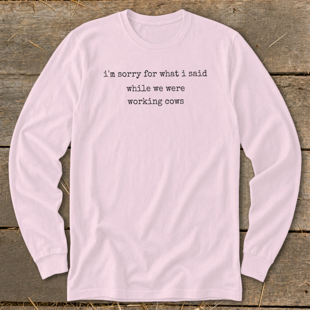 Pink long sleeve shirt with black text: "i'm sorry for what i said while we were working cows."