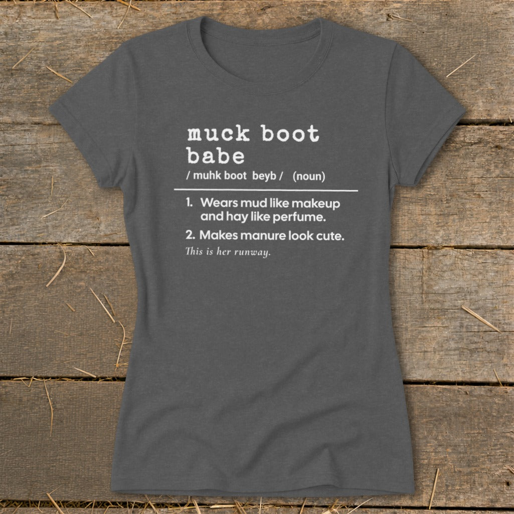 Gray t-shirt with "muck boot babe" definition: "Wears mud like makeup and hay like perfume. Makes manure look cute."