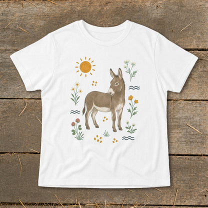 White t-shirt with a watercolor illustration of a donkey surrounded by flowers and the sun.