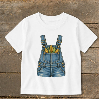 White t-shirt with illustration of denim overalls filled with corn cobs.