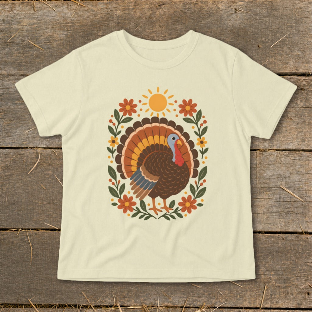 Cream t-shirt with a vintage-style turkey and floral sun design.