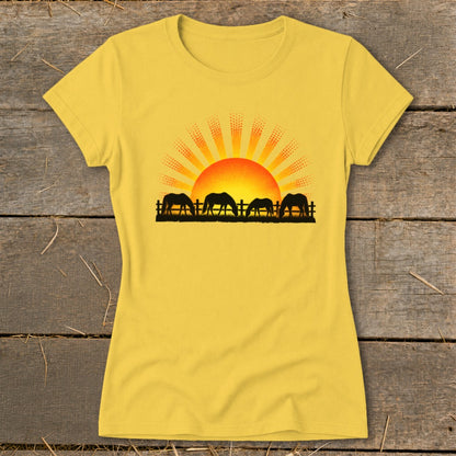 Yellow t-shirt with a graphic of horses grazing at sunrise behind a fence.