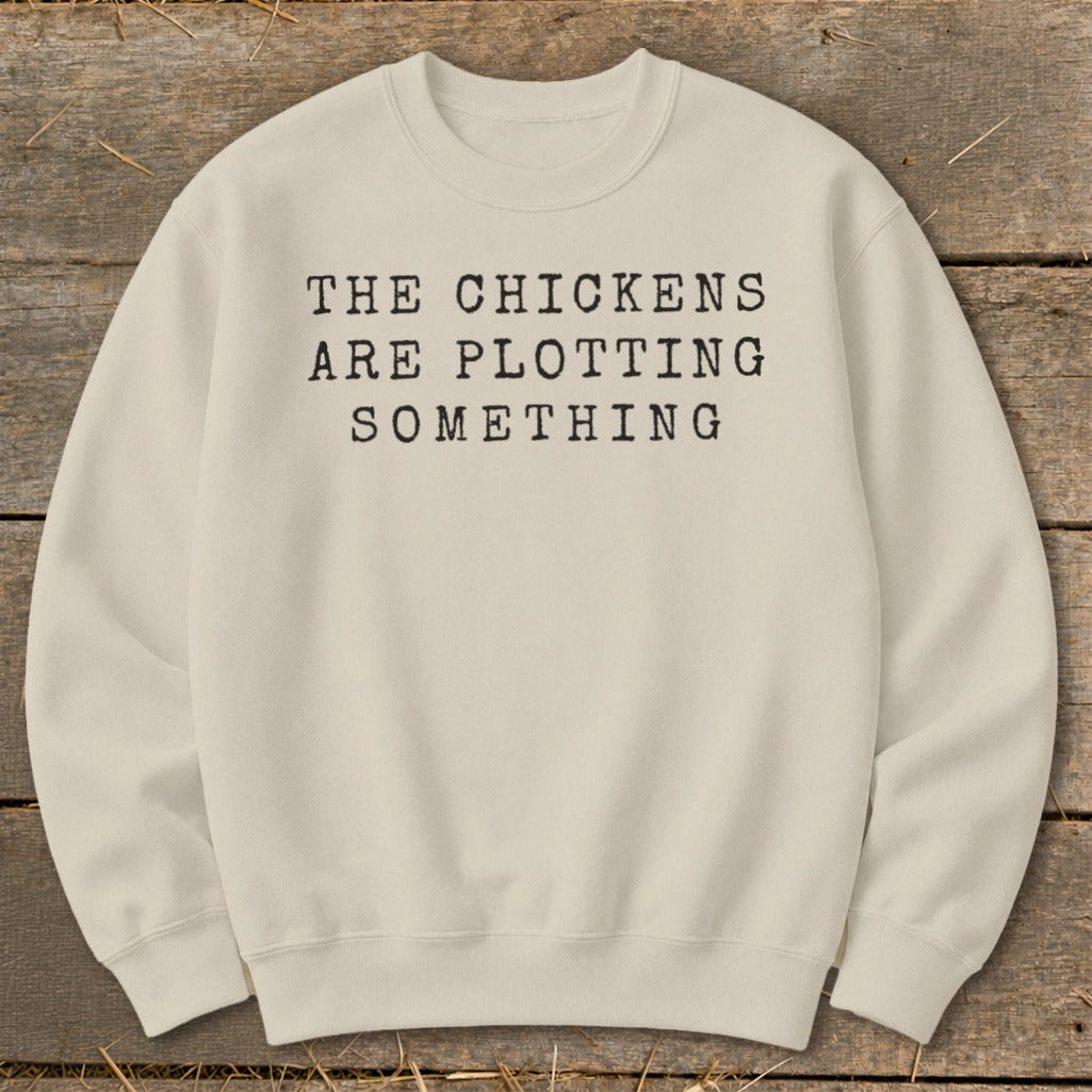 Cream sweatshirt with text "The chickens are plotting something."