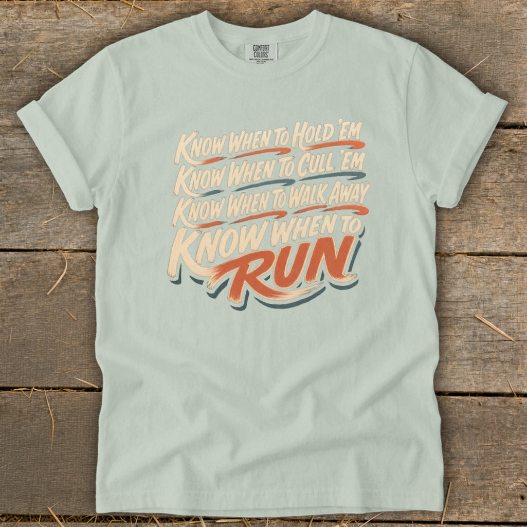 Light blue t-shirt with text: Know When To Hold 'Em, Cull 'Em, Walk Away, Run.