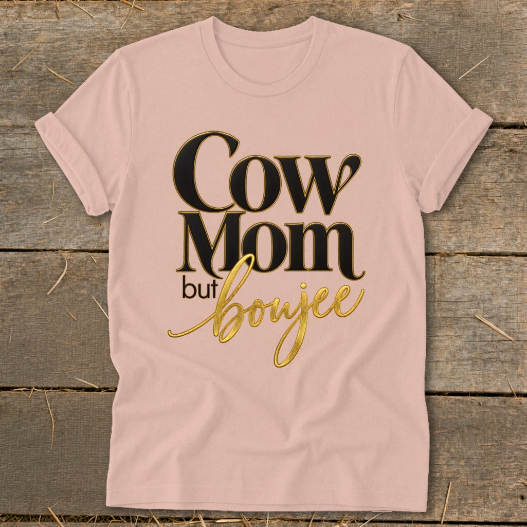 Pink t-shirt with "Cow Mom but boujee" graphic in black and gold text.