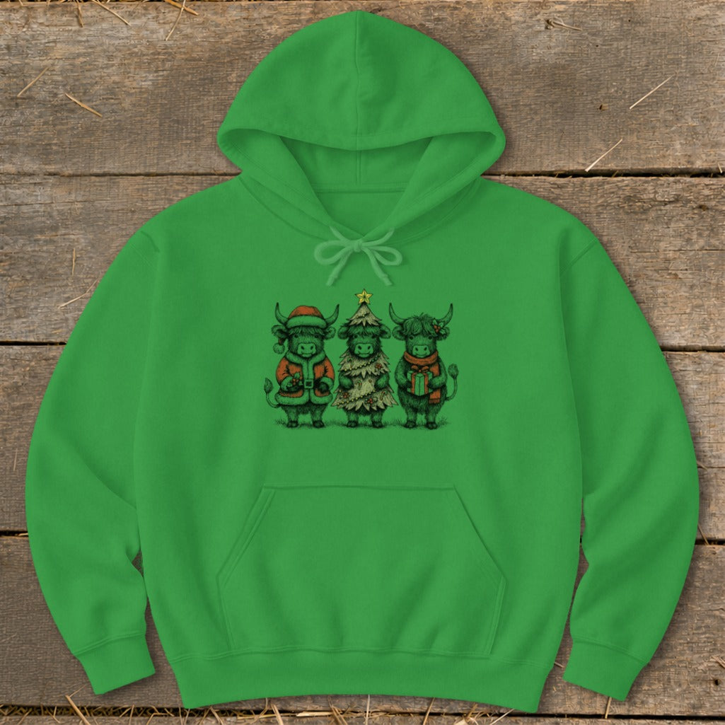 Three Highland cows in holiday attire: one as Santa, one as a Christmas tree, one with a gift.