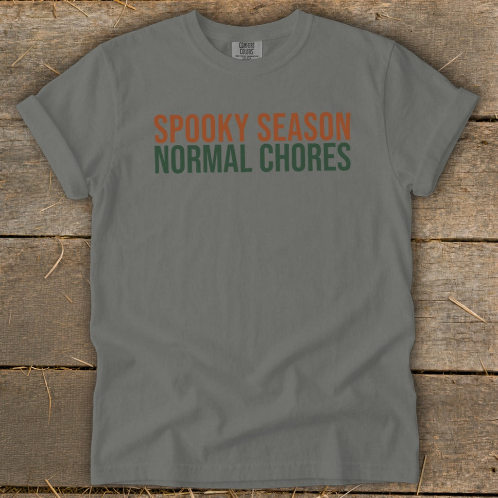Grey t-shirt with orange text "SPOOKY SEASON" and green text "NORMAL CHORES".