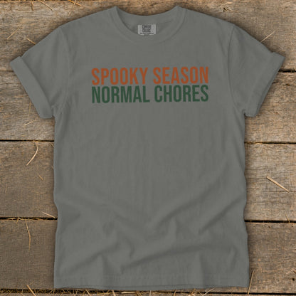Grey t-shirt with orange text "SPOOKY SEASON" and green text "NORMAL CHORES".