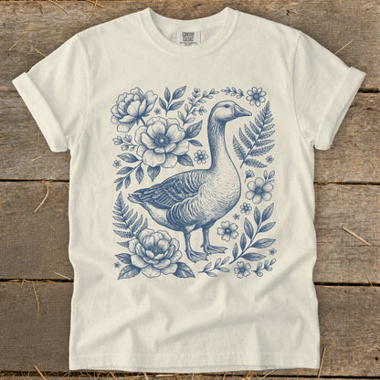 Cream t-shirt with blue goose and floral sketch print.