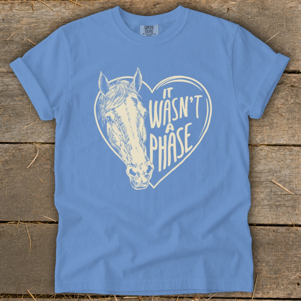Light blue t-shirt with horse head inside a heart with text "It wasn't a phase".