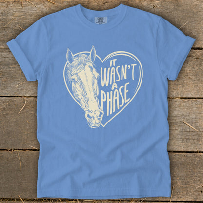 Light blue t-shirt with horse head inside a heart with text "It wasn't a phase".