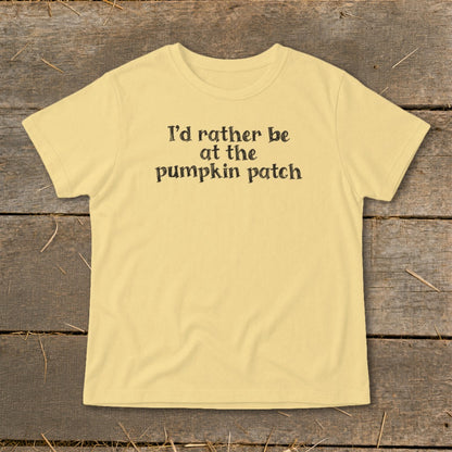 Yellow t-shirt with black text reading "I'd rather be at the pumpkin patch".