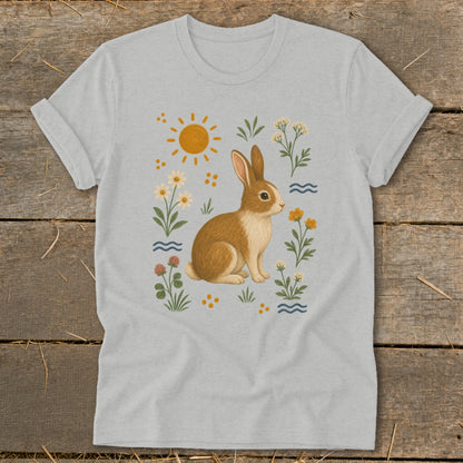 Light gray t-shirt with a brown bunny surrounded by wildflowers and a sun.
