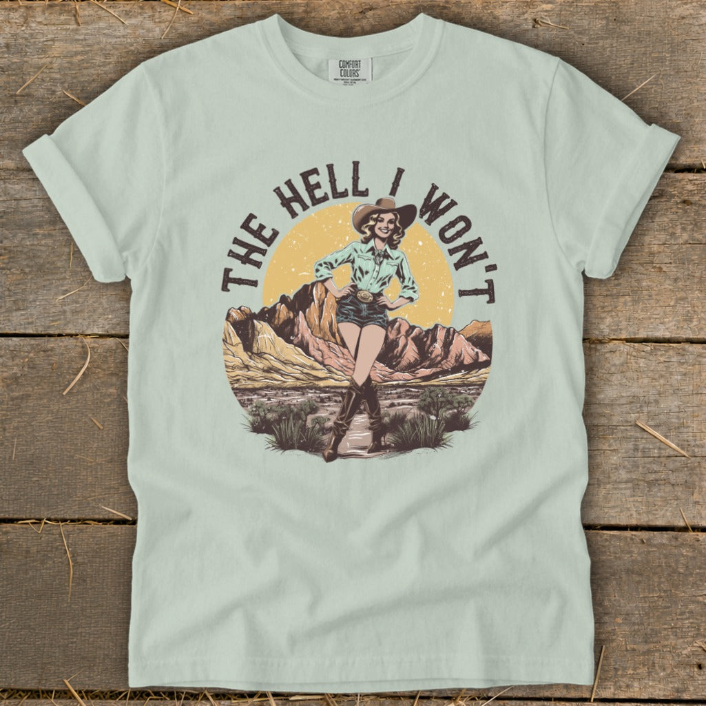 Cowgirl with text "The Hell I Won't" in desert landscape.