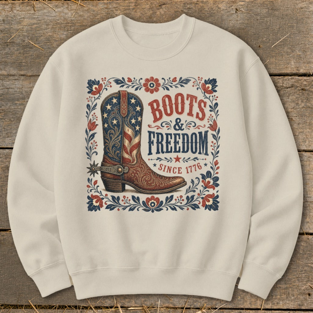 Cream sweatshirt with "Boots & Freedom Since 1776" graphic and American flag cowboy boot.
