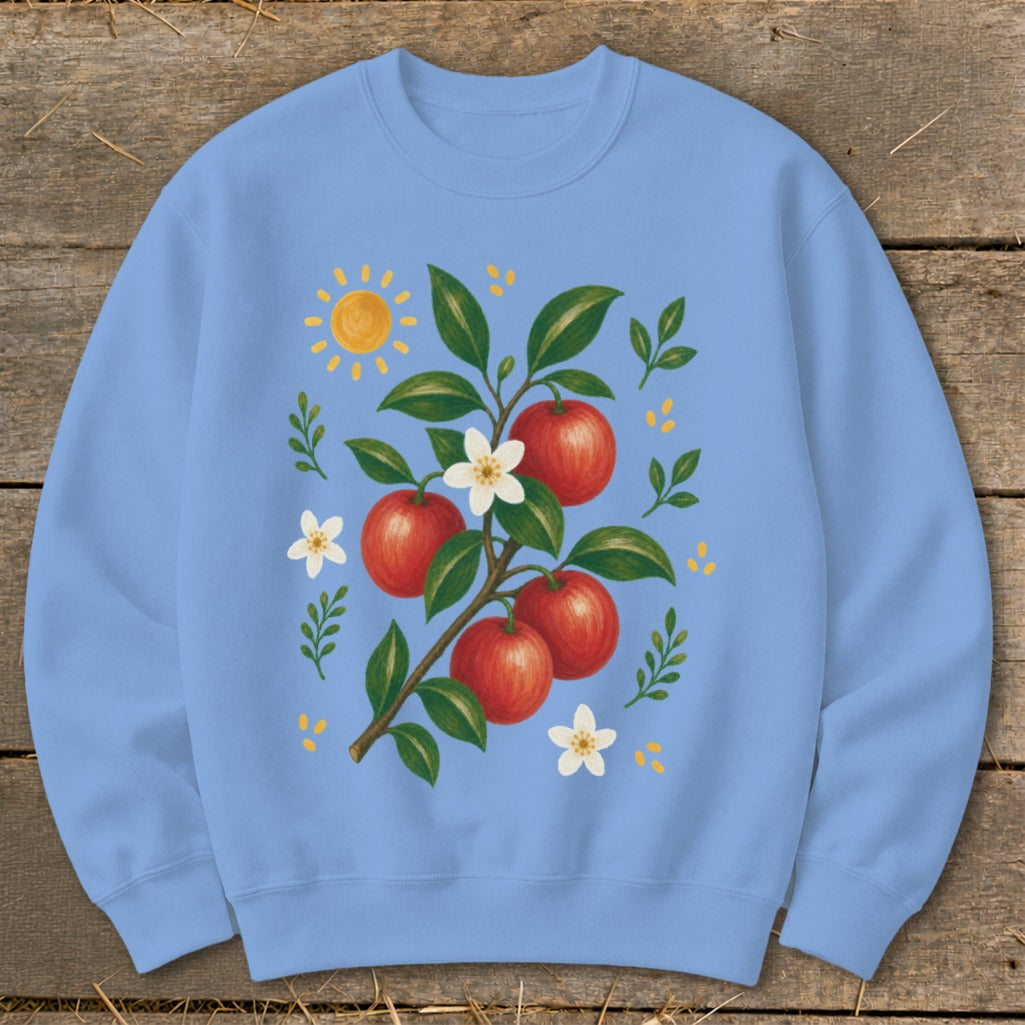 Light blue sweatshirt with an illustration of apples on a branch, flowers, and a sun.