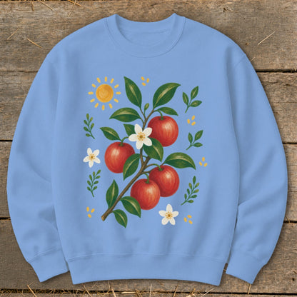 Light blue sweatshirt with an illustration of apples on a branch, flowers, and a sun.