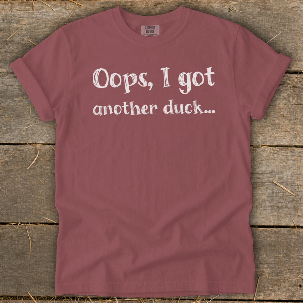 Maroon t-shirt with white text "Oops, I got another duck..."
