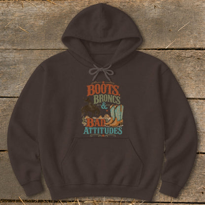 Brown hoodie with "Boots, Broncs & Bad Attitudes" graphic featuring cowboy boots.