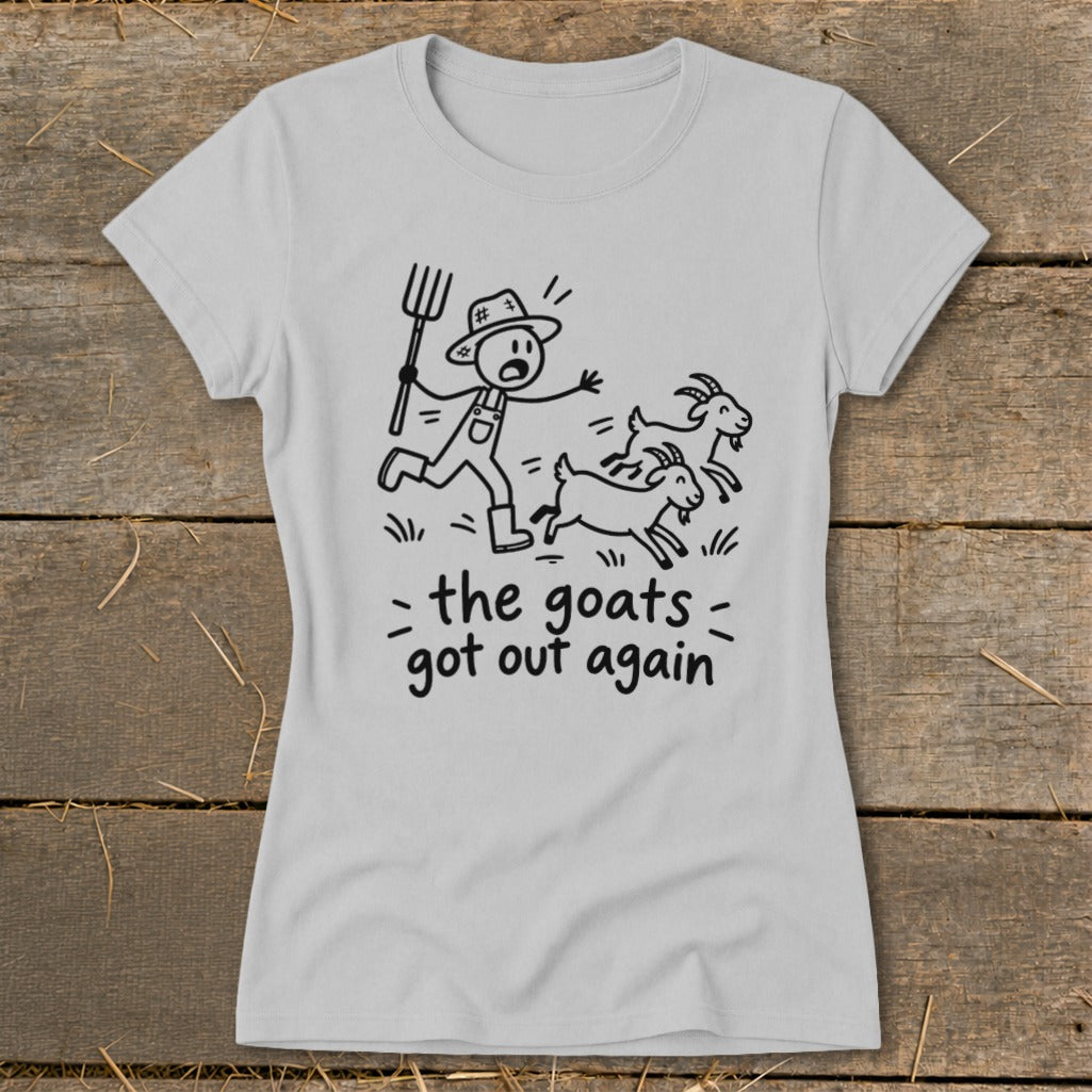 Light gray t-shirt with a stick figure farmer chasing goats, reads "the goats got out again."