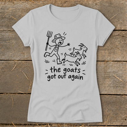 Light gray t-shirt with a stick figure farmer chasing goats, reads "the goats got out again."