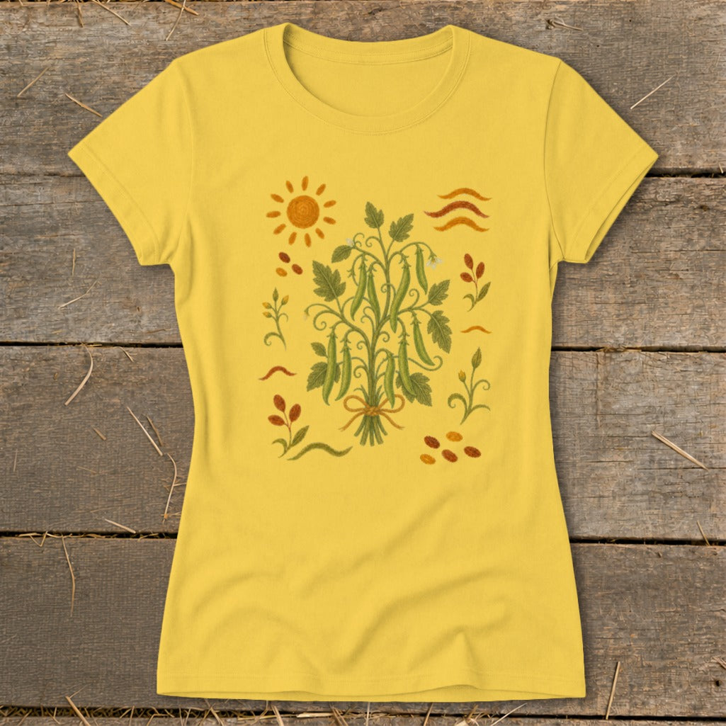 Yellow t-shirt with a botanical illustration of a pea plant and sun motif.